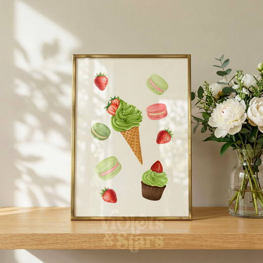 Framed artwork of ice cream cones, macarons, and strawberries on a wooden surface with a vase of flowers.