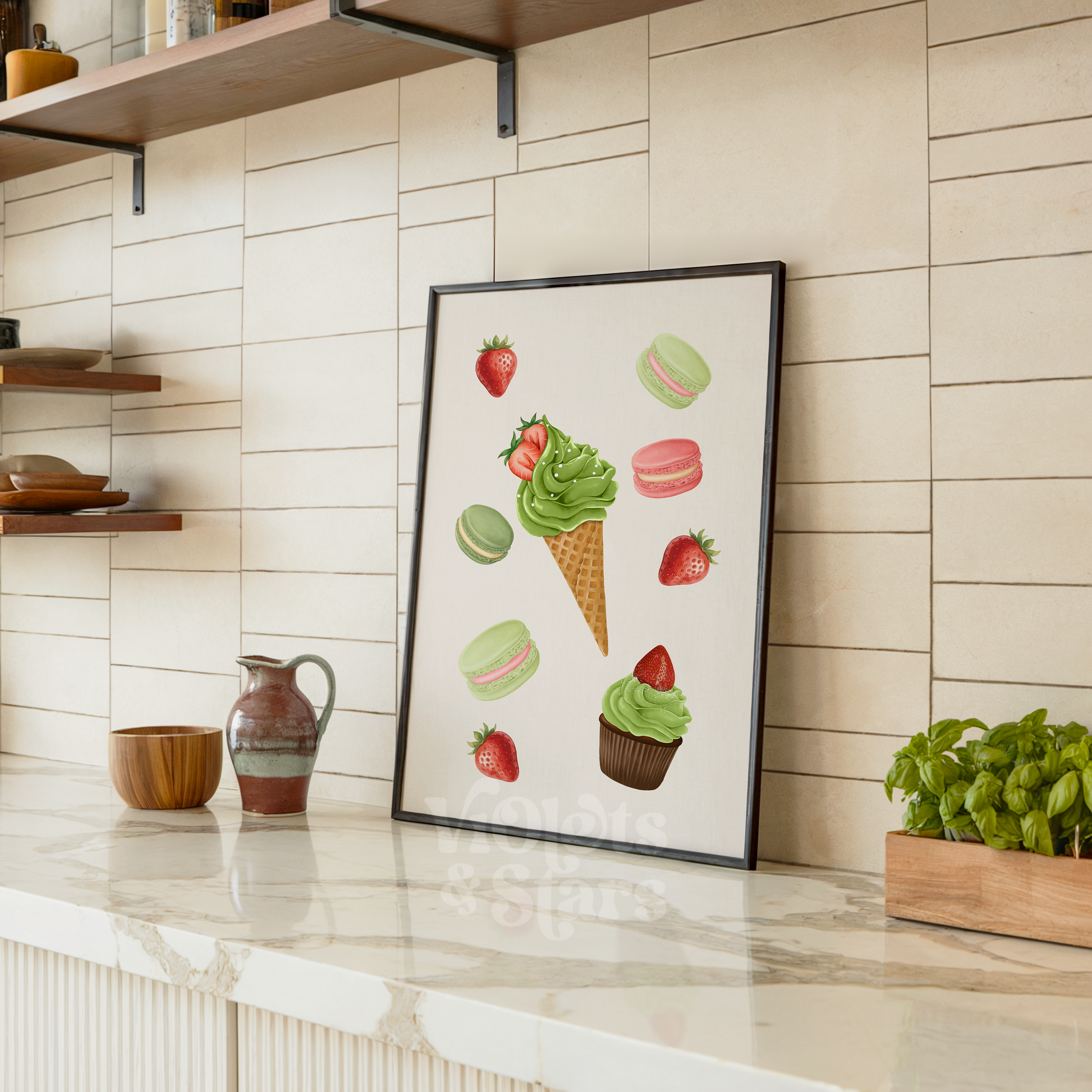 Framed artwork of ice cream cones and strawberries on a kitchen counter.
